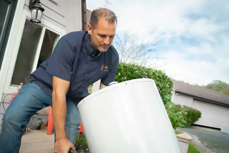 HOTCO owner delivering a brand-new water heater to a customer home for same-day replacement - Free Delivery