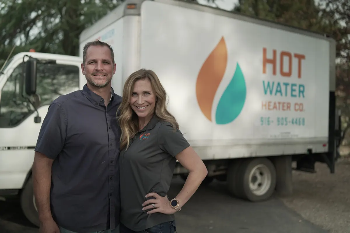HOTCO founders Jen and Doug standing in front of their Hot Water Heater Company truck in Placer County, CA