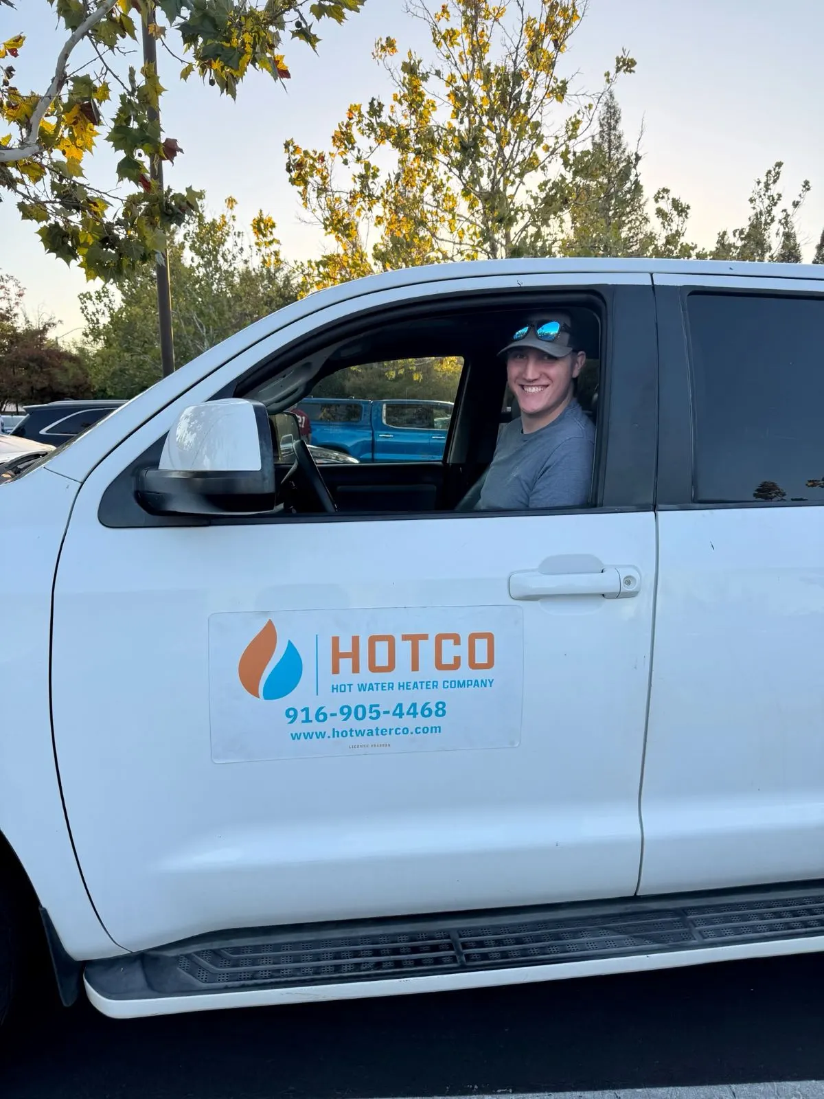 HOTCO technician unloading a new water heater from the service van for a same-day install