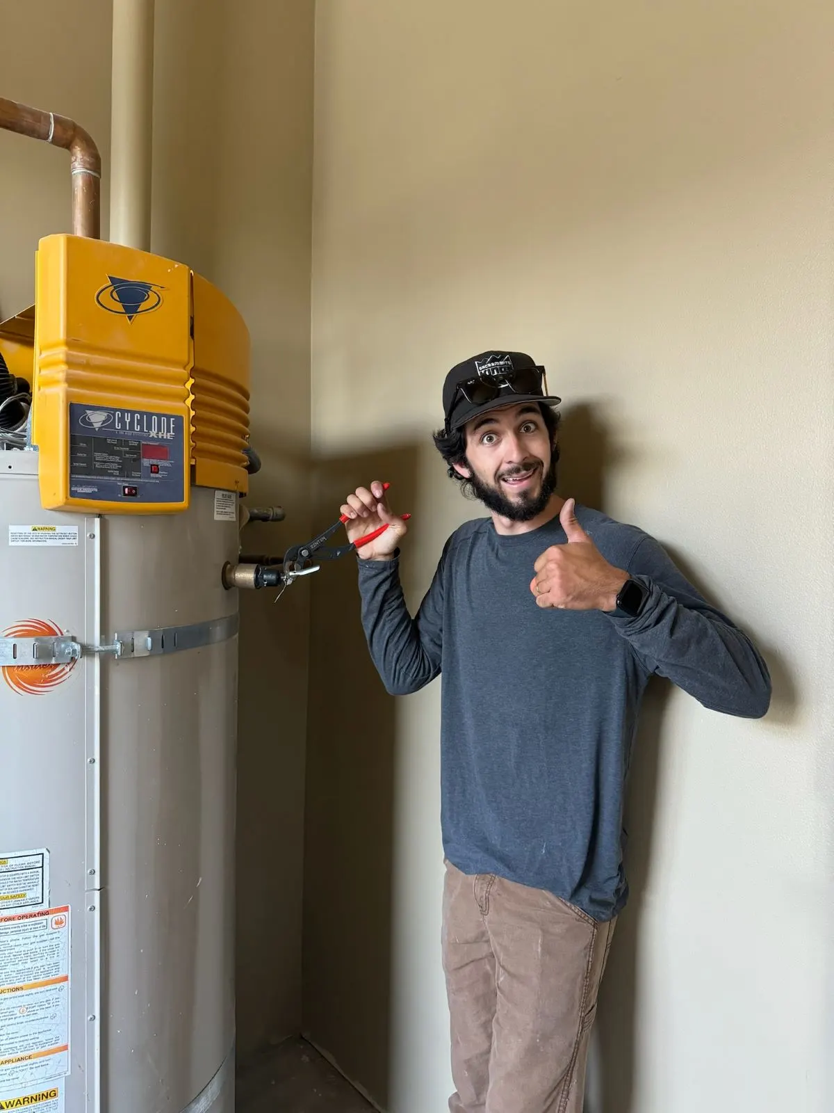 HOTCO water heater repair technician giving a thumbs up after fixing a water heater in Roseville - Water Heater Repair