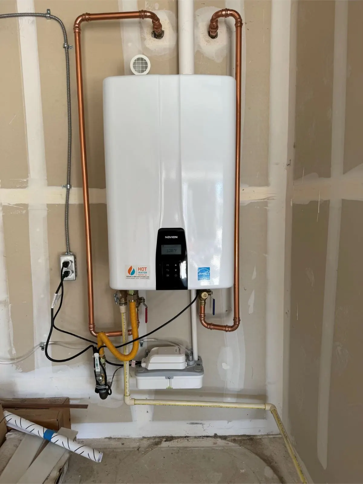 Navien tankless water heater with copper piping professionally installed by HOTCO in a Sacramento home - Tankless Installation