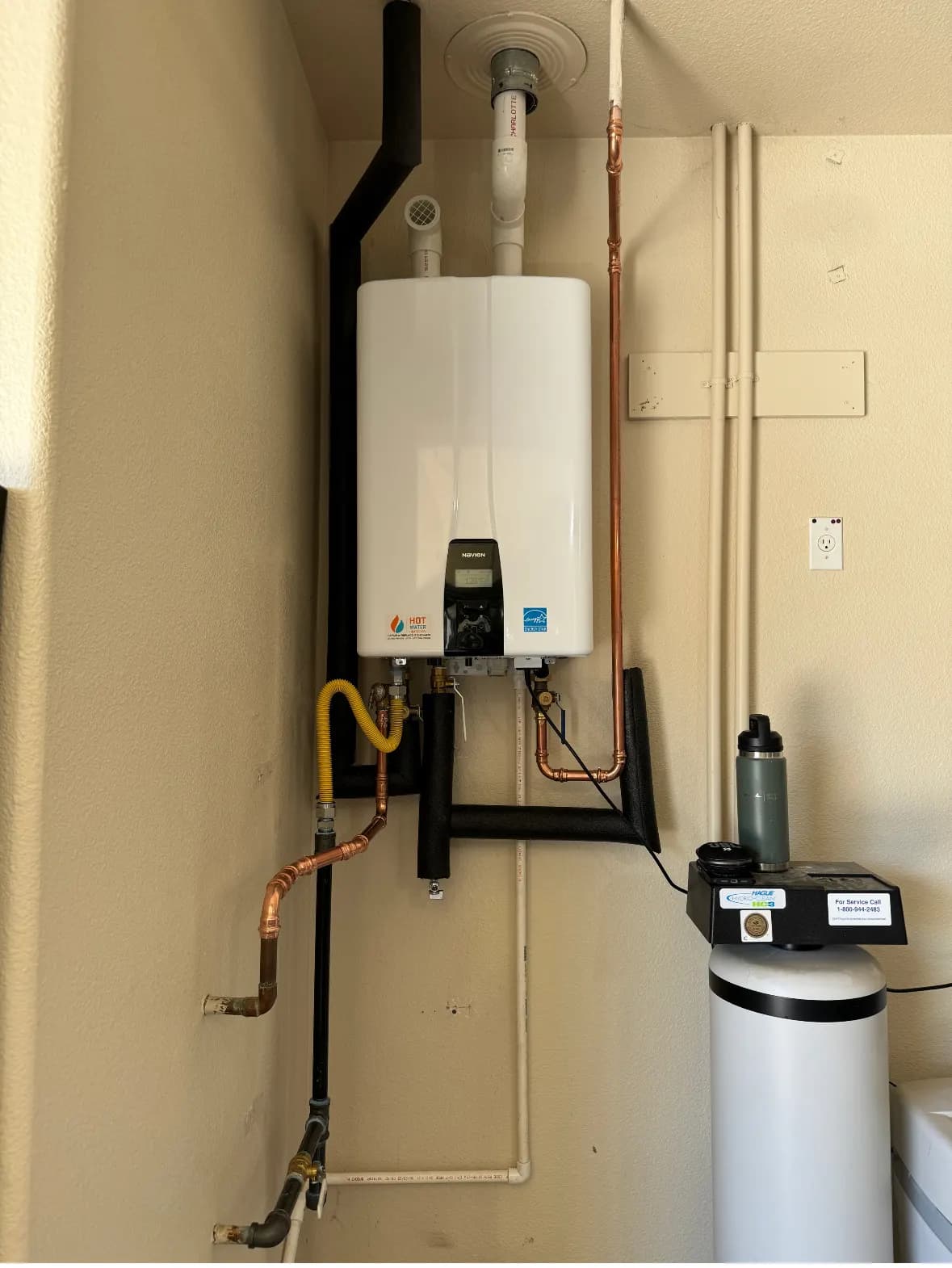 Wall-mounted tankless water heater installation with gas line and water softener in a Rocklin garage - Recirculation Pumps